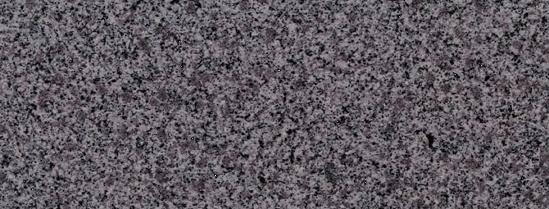 superficie de granito Hisar Grey con tono gris equilibrado y textura cristalina fina