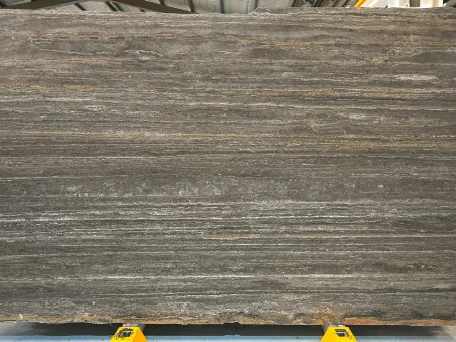 honed Titanium Travertine slab with linear vein movement